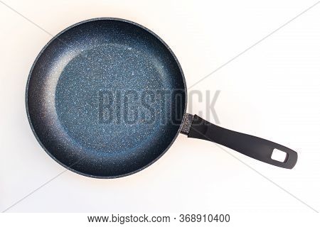 A Black Frying Pan Isolated On White Background