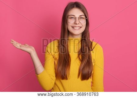Picture Of Cheerful Attractive Charming Young Lady Having Gap In Teeth, Looking Directly At Camera, 