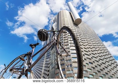 Copenhagen. Denmark. July 23, 2019. Bicycle In Front Of The Facade Of A Modern Metal Building On A B