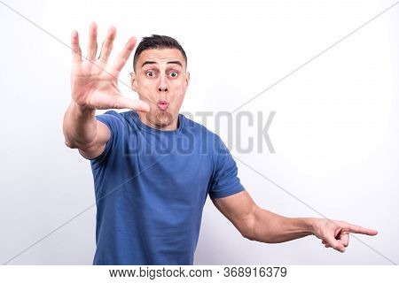 Surprised Man Pointing To Copy Space
