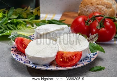 Making Of Fresh Caprese Salad With Soft Italian Cheese From Campania Buffalo Mozzarella With Tomatoe