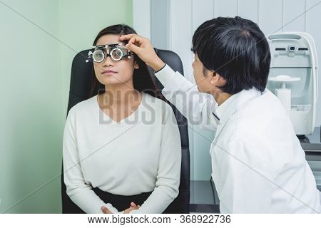 Consultation With An Ophthalmologist. Young Asian Woman And Doctor