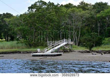 Dock An A Marsh Along A Tidal River.