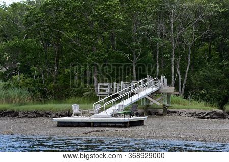 Dock And Pier On The Beach Along A River.