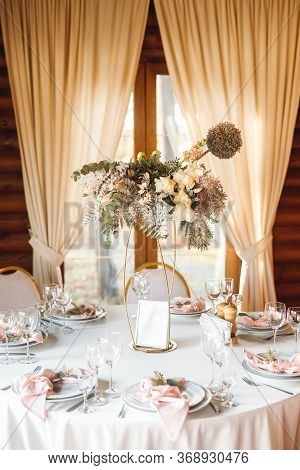 Festive Table Setting With Empty Wine Glasses And Fresh Flowers