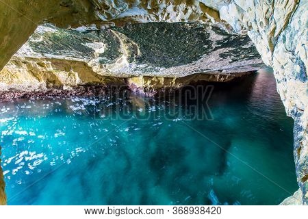 Israel. Karst cave Rosh-a-Nikra on the shores of the Mediterranean Sea. The color of sea water changes from azure to dark blue. The concept of active, environmental and photo tourism