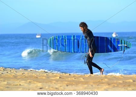 Hossegor, Landes, France. 10.08.2019. Surfer With A Surfboard. Sunset Sea Sand Beach Landscape. Outd