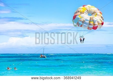 Bavaro Beach, Punta Cana, Dominican Republic - March, 2020: Tourists Parasailing On Bavaro Beach In 