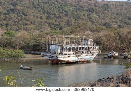 MUMBAI, INDIA - FEBRUARY 15, 2020: Abandoned tourist boat on Elefanta Island near Mumbai, India