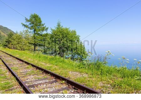 Rails Of The Trans-siberian Railway On The Shore Of Baikal Lake Going Into The Distance. Summer On C
