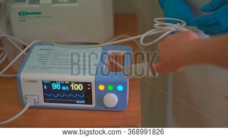 Pulse Oximeter At Work. Medical Diagnostic Equipment. Patients Hand With Attached Pulse Oximeter Sen