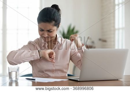 Unhappy Millennial Woman Checking Time To Workday Finish.