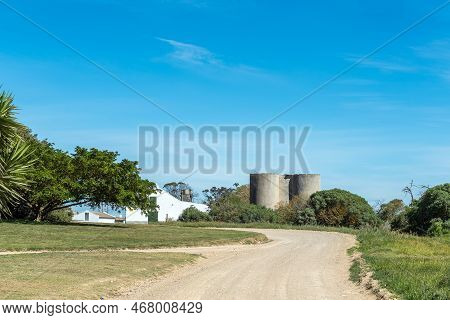 Struisbaai, South Africa - Sep 22, 2022: Silos And Barns At Prinskraal Next To The Road Between Arni