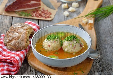 Delicious South Tyrolean Bacon Dumplings Soup With Hot Beef Broth And Chives
