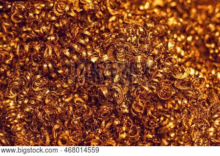 Yellow Metal Shavings From Lathe Close-up. Abstract Industrial Background. Golden Fleece..