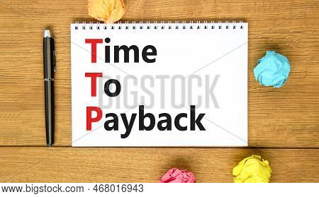 Ttp Time To Payback Symbol. Concept Words Ttp Time To Payback On White Note On A Beautiful Wooden Ba