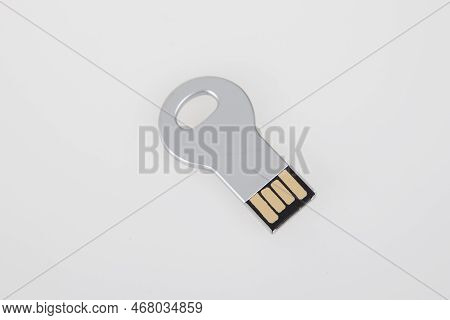 Usb Key Silver Flash Drive Grey Stick Memory Steel On White Desk Background
