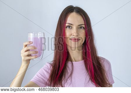 Beautiful Young Woman Holds A Glass With A Pink Drink Or Cocktail Of Electrolyte Powder Or Hydrolyse