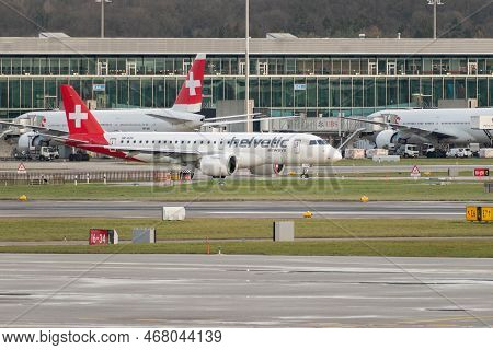 Zurich, Switzerland, December 23, 2022 Helvetic Airways Embraer E190-e2 Aircraft Is Taxiing To Its P