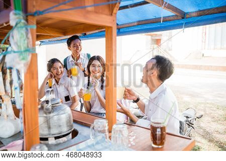 Group Of Asian Students Chatting While Enjoying A Drink