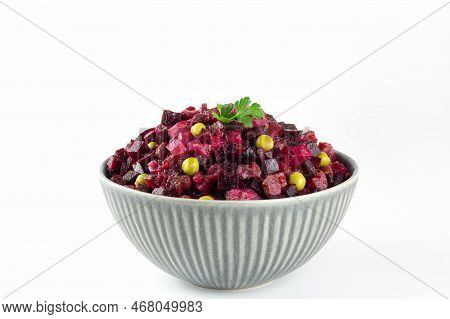 Traditional Russian Vinaigrette Salad On A White Background. Salad Of Beets, Potatoes, Carrots And G