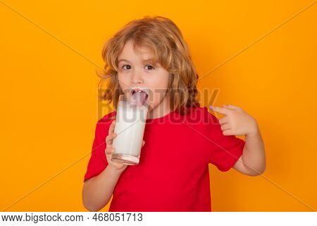 Cute Little Child With Glass Of Milk On Studio Color Background. Kid With Milk Moustache. Fun Portra