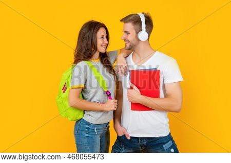 Guy And Girl Hold Notebook. University Students On Yellow Background. Study With Workbook.