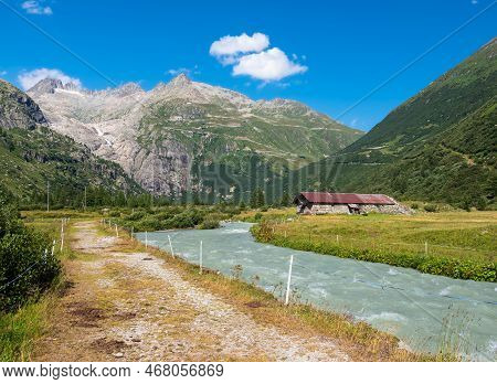 River Rhone And A View At The Rhone Glacier From Village Gletsch In Switzerland