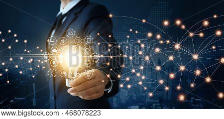 Creativity And Idea Of Business, Businessman Holding Light Bulb With Brain Inside And Icon Network C