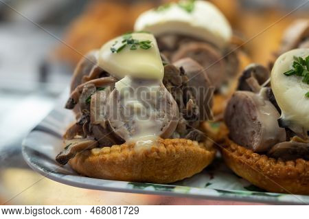 French Mini Quiche Pie With Goat Cheese And Traditional French Sausage Andouillette From Troyes In B
