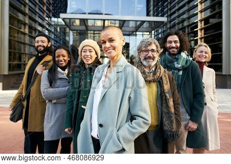 A Group Of Smiling Business People From A Company Led By An Empowered Shaved Air Woman. Cheerful Loo