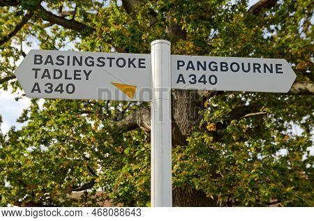 White Plastic Road Sign On The Main A340 Road In Aldermaston, Berkshire.  The Village Is Between Bas