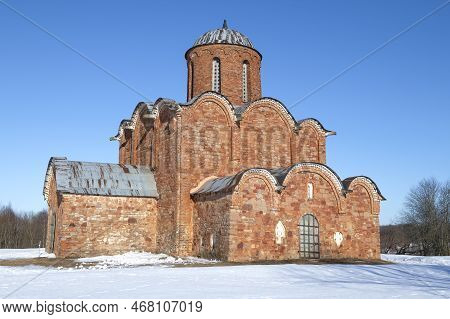 Medieval Church Of The Transfiguration Of The Savior On Kovalev (1345) On A Sunny March Day. Neighbo