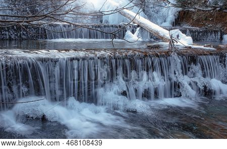 Frozen Waterfall. Mountain Water Cascades Covered With Ice