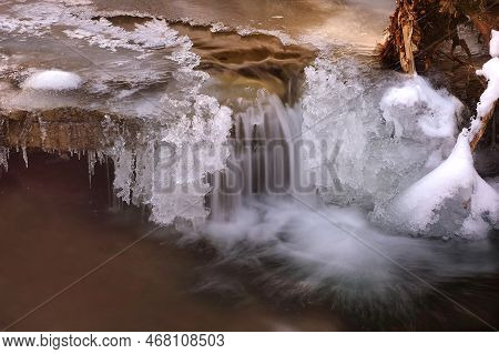 Frozen Waterfall. Mountain Water Cascades Covered With Ice