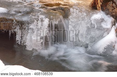 Frozen Waterfall. Mountain Water Cascades Covered With Ice