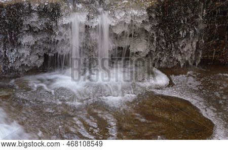 Frozen Waterfall. Mountain Water Cascades Covered With Ice