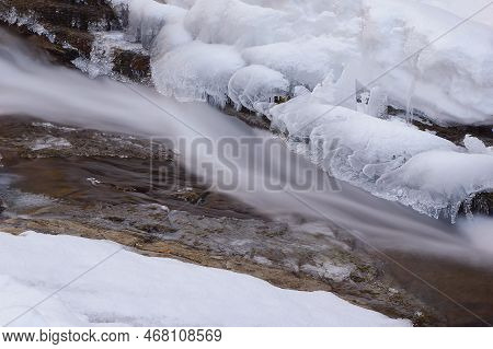 Frozen Waterfall. Mountain Water Cascades Covered With Ice