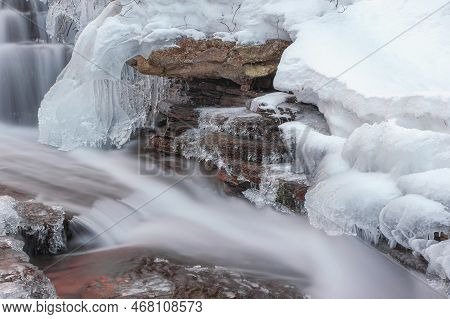 Frozen Waterfall. Mountain Water Cascades Covered With Ice