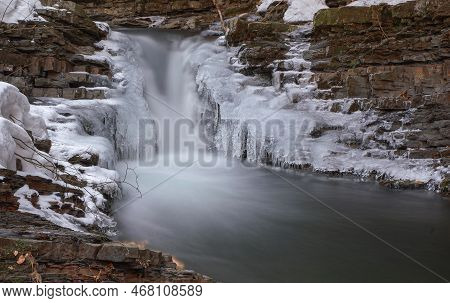 Frozen Waterfall. Mountain Water Cascades Covered With Ice