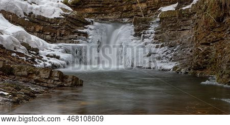 Frozen Waterfall. Mountain Water Cascades Covered With Ice