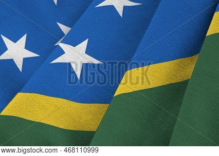 Solomon Islands Flag With Big Folds Waving Close Up Under The Studio Light Indoors. The Official Sym