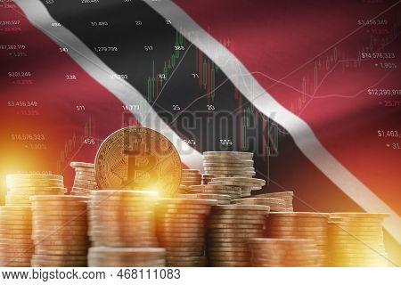 Trinidad And Tobago Flag And Big Amount Of Golden Bitcoin Coins And Trading Platform Chart. Crypto C