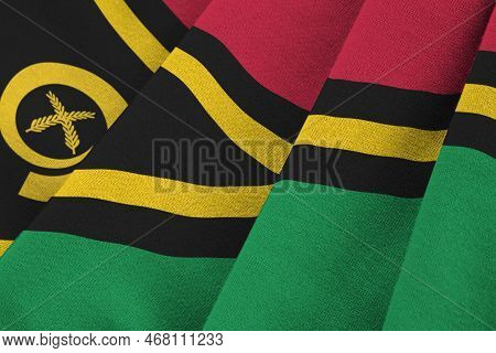 Vanuatu Flag With Big Folds Waving Close Up Under The Studio Light Indoors. The Official Symbols And