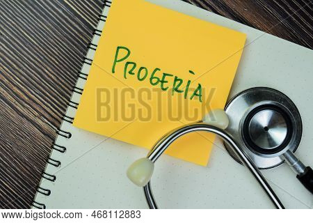 Concept Of Progeria Write On Sticky Notes With Stethoscope Isolated On Wooden Table.