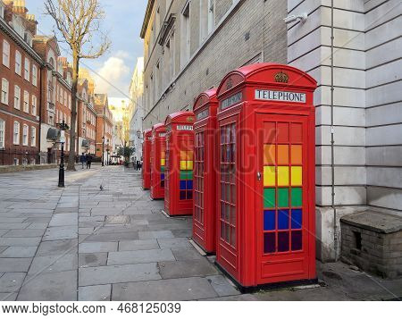 Red Telephone Booths With Lgbtq Rainbow Colors In London- London, United Kingdom - December 20, 2022