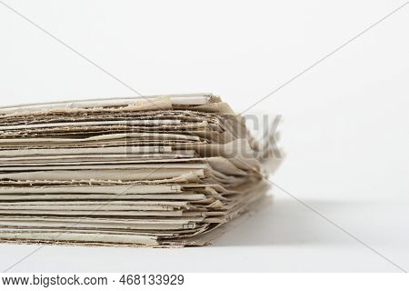 Stach Of Daily Newspapers On A Table. Pile Of Business Papers On White Background