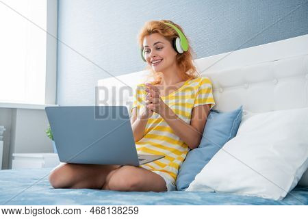Happy Woman In Headphones Has Webinar. Woman At Home Watch Webinar. Woman Having Webinar On Laptop