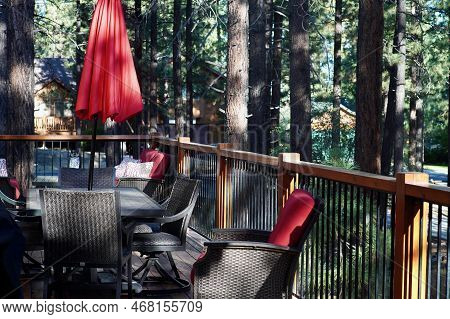 Patio Of A Vacation Log Cabin In California Big Bear During Summer Showing Pine Trees