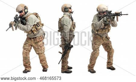 Soldier In Military Equipment With A Gun On A White Isolated Background, A Commando In Uniform With 